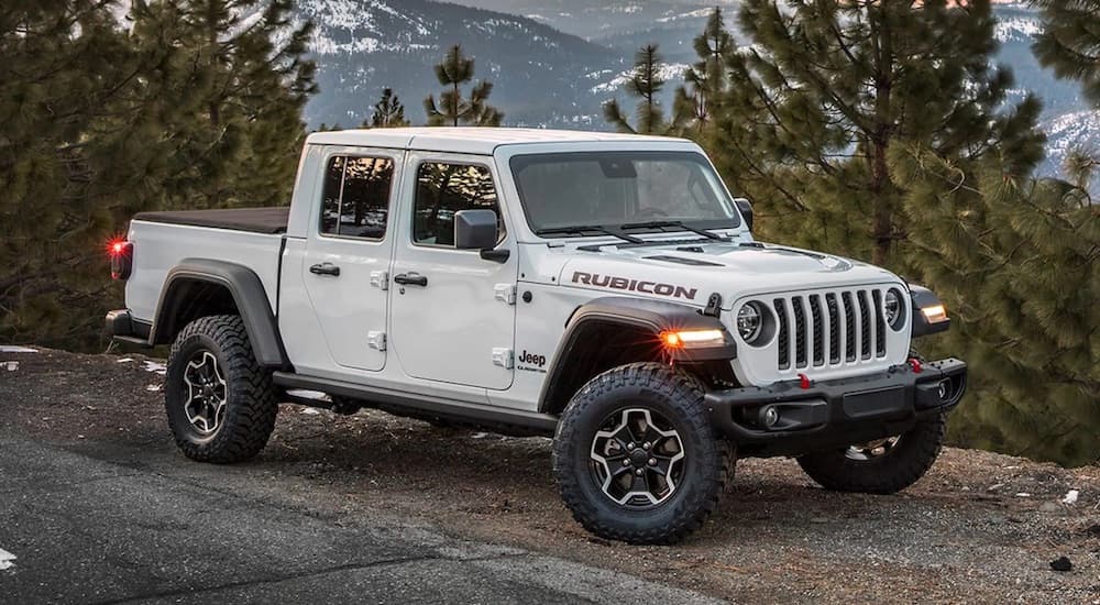 A white 2024 Jeep Gladiator Rubicon is shown from the front at an angle after leaving a Jeep dealer near Sycamore.